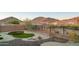 Relaxing backyard with artificial grass, desert landscaping, and mountain views at 8773 S 167Th Dr, Goodyear, AZ 85338