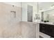 Modern bathroom featuring a glass-enclosed shower with pebble flooring and dual sink vanity at 8773 S 167Th Dr, Goodyear, AZ 85338