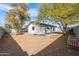 Spacious backyard with mature trees and a patio, offering privacy and a serene outdoor retreat at 8920 N 56Th Ave, Glendale, AZ 85302