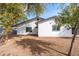 Landscaped backyard with mature trees, offering a private outdoor space for relaxation and recreation at 8920 N 56Th Ave, Glendale, AZ 85302