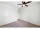 Simple bedroom featuring neutral carpet, white walls, and a ceiling fan at 8920 N 56Th Ave, Glendale, AZ 85302