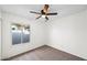 Bedroom with a window allowing natural light to flood the space, and a ceiling fan at 8920 N 56Th Ave, Glendale, AZ 85302