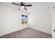 Cozy bedroom with carpet, a window offering natural light and a ceiling fan at 8920 N 56Th Ave, Glendale, AZ 85302