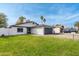 Charming single-story home with a well-maintained lawn and a two-car garage on a sunny day at 8920 N 56Th Ave, Glendale, AZ 85302