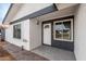 Inviting front entrance featuring a well-lit porch and a stylish front door with sidelights and a window at 8920 N 56Th Ave, Glendale, AZ 85302