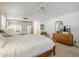 Serene main bedroom featuring natural light, neutral walls and flooring, and a spacious closet at 9420 W Taro Ln, Peoria, AZ 85382