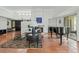 Open living room featuring a fireplace, piano, and sliding glass doors to the outdoors at 9457 N 80Th Pl, Scottsdale, AZ 85258