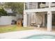 Relaxing backyard featuring a pool, lawn, two hanging cocoon chairs under a covered patio and a built-in grill at 971 E Driftwood Dr, Tempe, AZ 85283