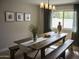 Elegant dining room featuring a wooden table with benches, a chandelier, and ample natural light, perfect for gatherings at 971 E Driftwood Dr, Tempe, AZ 85283