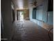 A living room features unfinished walls, wooden floors and a ceiling fan at 9716 E Birchwood Ave, Mesa, AZ 85208