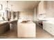 Bright, modern kitchen featuring stainless steel appliances, a large island with seating, and a neutral color palette at 9790 N 56Th St, Paradise Valley, AZ 85253