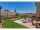 Entertaining backyard boasts artificial turf, a playground, and a cozy seating area at 11101 N 82Nd Dr, Peoria, AZ 85345