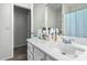 Well-lit bathroom featuring a white vanity with ample countertop space and a neutral-toned tiled floor at 11101 N 82Nd Dr, Peoria, AZ 85345