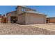 Beige two-story home with a two car garage, desert landscaping, and a well-maintained facade at 11101 N 82Nd Dr, Peoria, AZ 85345