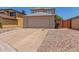 Exterior shot of a two-car garage featuring a concrete driveway and low maintenance landscaping at 11101 N 82Nd Dr, Peoria, AZ 85345