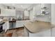 Functional kitchen featuring ample counter space, white cabinets, modern appliances, and tile flooring at 11101 N 82Nd Dr, Peoria, AZ 85345