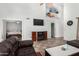 Inviting living room featuring tile floors, electric fireplace, vaulted ceilings, and neutral walls at 11101 N 82Nd Dr, Peoria, AZ 85345