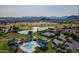 Aerial view of a community featuring a golf course, lake, pool, tennis courts, and a playground at 1145 E Silktassel Trl, San Tan Valley, AZ 85143