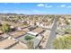 Wide aerial shot showcasing a residential neighborhood with houses, green spaces, and a mountain backdrop at 1145 E Silktassel Trl, San Tan Valley, AZ 85143