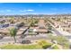 Scenic aerial view of a neighborhood with neat rows of houses and lush green trees lining the streets at 1145 E Silktassel Trl, San Tan Valley, AZ 85143