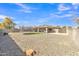 Expansive backyard featuring gravel, a trampoline, manicured faux grass, and mature trees at 1145 E Silktassel Trl, San Tan Valley, AZ 85143