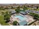 An aerial shot features the community pool with plenty of lounge chairs and umbrellas for shade at 1145 E Silktassel Trl, San Tan Valley, AZ 85143