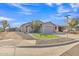 Attractive exterior shot of a home with a well-groomed yard, desert plants, and an attached garage at 1145 E Silktassel Trl, San Tan Valley, AZ 85143