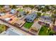 An aerial view shows a home with a manicured backyard lawn, a detached garage and mature trees in a fenced-in yard at 118 W Palm Ln, Phoenix, AZ 85003