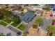 An aerial view of a well-maintained single Gathering home in a quiet neighborhood, featuring lush green lawns and mature trees at 118 W Palm Ln, Phoenix, AZ 85003