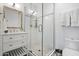 Modern bathroom with a glass-enclosed shower, white vanity, and stylish fixtures at 118 W Palm Ln, Phoenix, AZ 85003