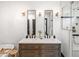 Modern bathroom with double vanity, sconces, stone countertop, and glass enclosed shower at 118 W Palm Ln, Phoenix, AZ 85003