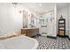 This stylish bathroom features a modern tub, patterned floor tiles, double vanity and geometric light fixtures at 118 W Palm Ln, Phoenix, AZ 85003