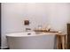 Close-up of a modern freestanding bathtub with a wooden tray and stylish fixtures at 118 W Palm Ln, Phoenix, AZ 85003