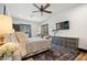 Well-lit bedroom with a ceiling fan, TV, and gray dresser, creating a cozy atmosphere at 118 W Palm Ln, Phoenix, AZ 85003