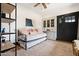 Charming bedroom featuring a daybed, custom built-ins, neutral tones, and stylish decor at 118 W Palm Ln, Phoenix, AZ 85003