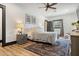 Comfortable bedroom with a ceiling fan, soft rug, and stylish furnishings at 118 W Palm Ln, Phoenix, AZ 85003