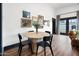 Dining area with wood floors, a round table with decor, and framed wall art at 118 W Palm Ln, Phoenix, AZ 85003