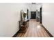 Hallway with hardwood floors, neutral paint, and views to the living room and entrance at 118 W Palm Ln, Phoenix, AZ 85003