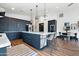 Spacious kitchen featuring dark cabinetry, stainless steel appliances, and an island with pendant lighting at 118 W Palm Ln, Phoenix, AZ 85003