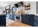 Stylish kitchen boasts dark cabinets, stainless steel appliances, and butcher block on floating shelves at 118 W Palm Ln, Phoenix, AZ 85003