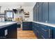 Well-designed kitchen featuring dark cabinets, a stainless steel oven, and white countertops at 118 W Palm Ln, Phoenix, AZ 85003