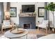 Living room showcases brick fireplace with wood mantle, TV, and neutral seating arrangement at 118 W Palm Ln, Phoenix, AZ 85003