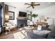 Bright living room with brick fireplace, wood mantle, TV, and comfortable seating at 118 W Palm Ln, Phoenix, AZ 85003