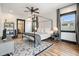 Spacious main bedroom with a canopy bed frame, accent rug, dark window trim and modern fixtures at 118 W Palm Ln, Phoenix, AZ 85003