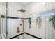 Modern shower with bronze fixtures, white tiling, a rain shower head and a glass partition at 118 W Palm Ln, Phoenix, AZ 85003