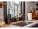 Close-up of a kitchen sink with a modern faucet and potted plants by the window at 118 W Palm Ln, Phoenix, AZ 85003