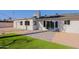 A small artificial lawn and stone patio complement this home's backyard space at 1215 E Cambridge Ave, Phoenix, AZ 85006