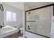 Modern bathroom featuring a sleek, glass-enclosed shower over tub and stylish vanity at 1215 E Cambridge Ave, Phoenix, AZ 85006