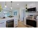 Kitchen with stainless steel appliances, white cabinetry, and an island with seating overlooking the dining and living spaces at 1215 E Cambridge Ave, Phoenix, AZ 85006