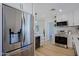 Bright kitchen featuring stainless steel refrigerator, wine cooler and modern white cabinetry at 1215 E Cambridge Ave, Phoenix, AZ 85006